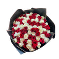 Bouquet of red and white roses in a black wrap 