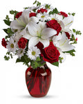Bouquet of red and white flowers in a vase 