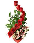 Bouquet of red roses and white lilies in a decorative holder