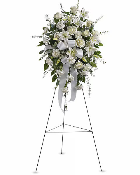 Floral arrangement on a stand with white flowers and greenery 